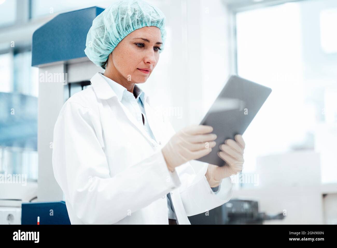 Female pharmacist using digital tablet at medical store Stock Photo