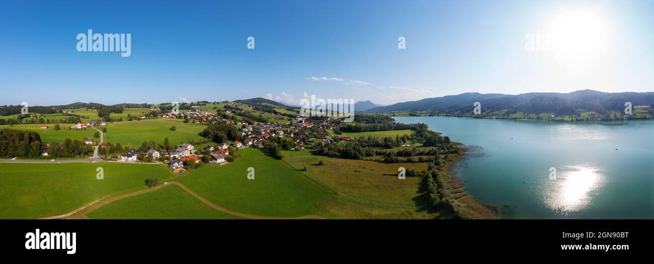 Austria, Upper Austria, Zell am Moos, Drone panorama of village on shore of Irrsee lake in summer Stock Photo