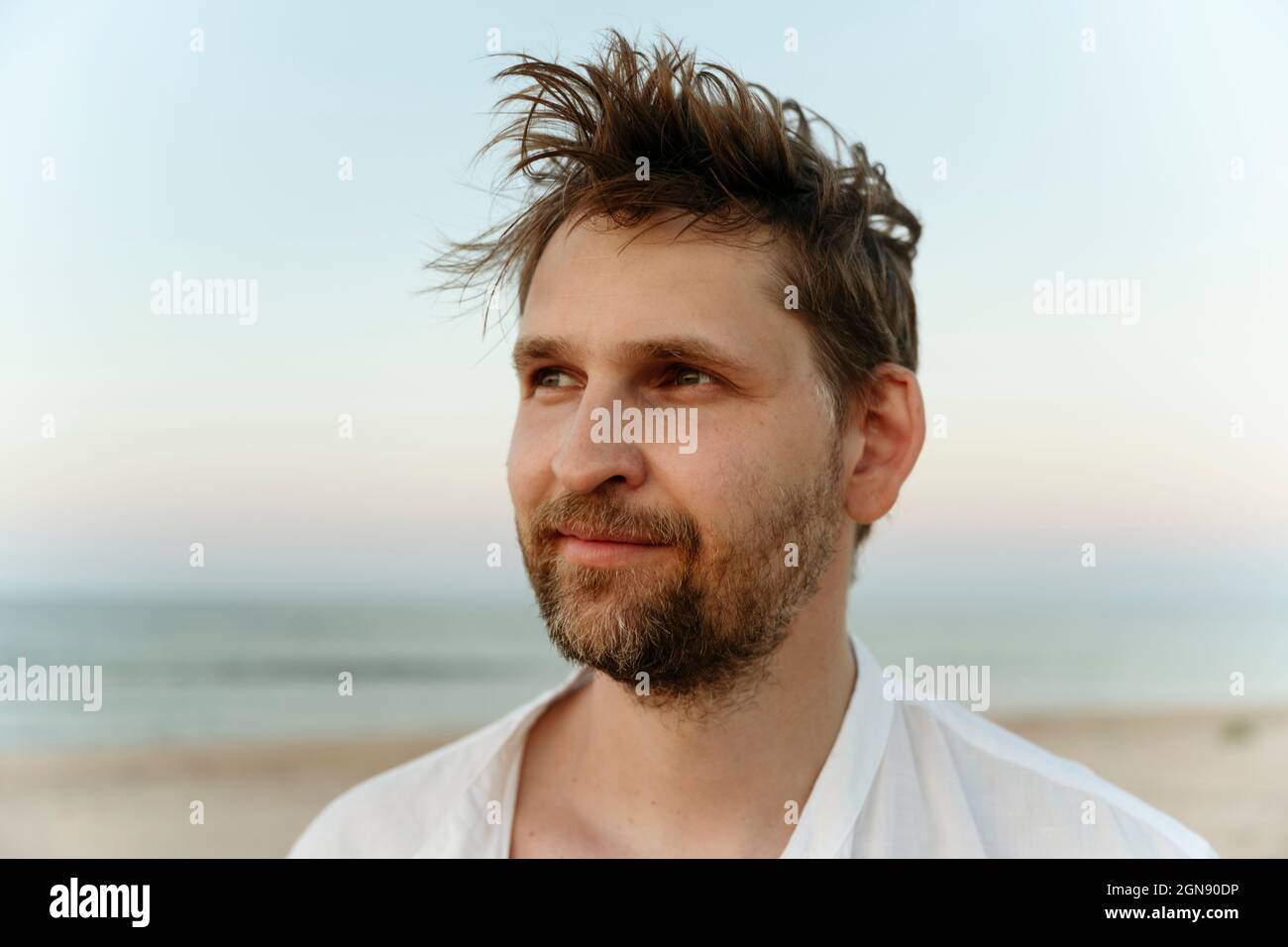 Smiling mid adult man with brown hair at beach Stock Photo