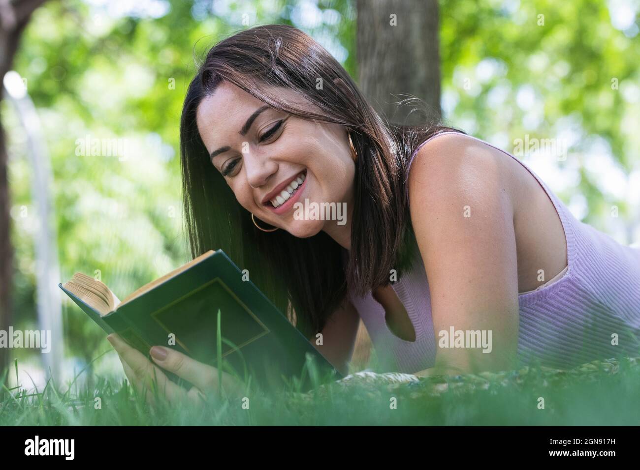 Young woman lying in reading hi-res stock photography and images - Alamy
