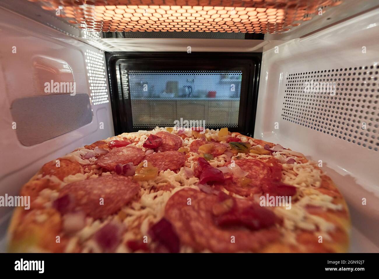 Heating pizza in a microwave oven Stock Photo Alamy