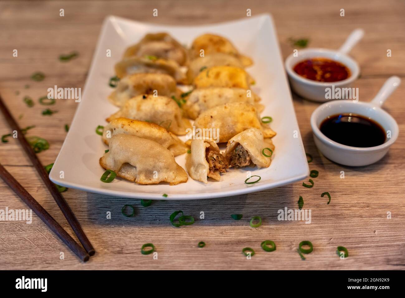 Fried beef dumplings, traditional Chinese dish with soy and chili sauce Stock Photo