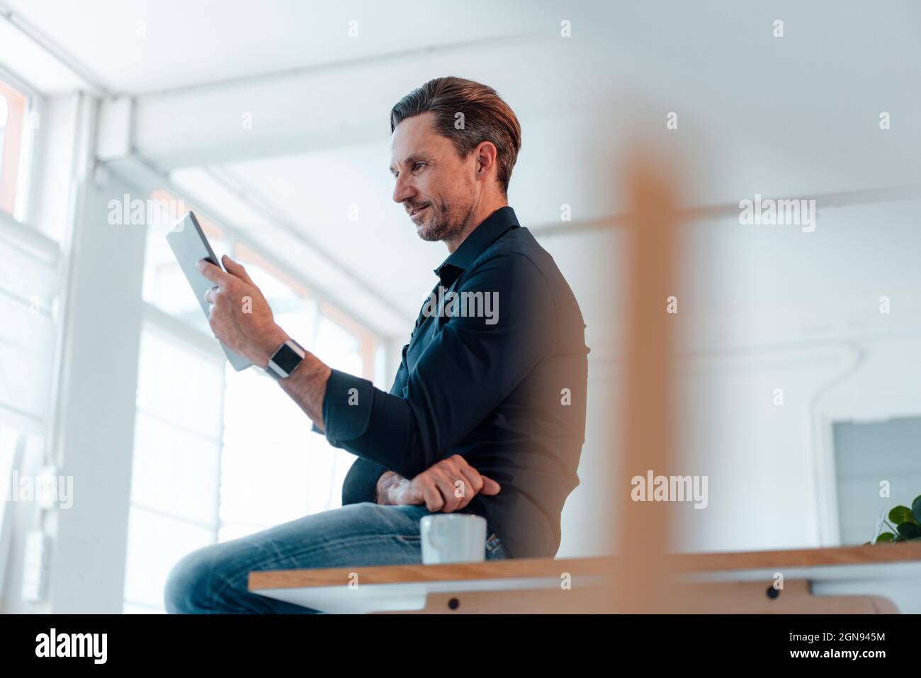 Thoughtful businessman having coffee at work place Stock Photo