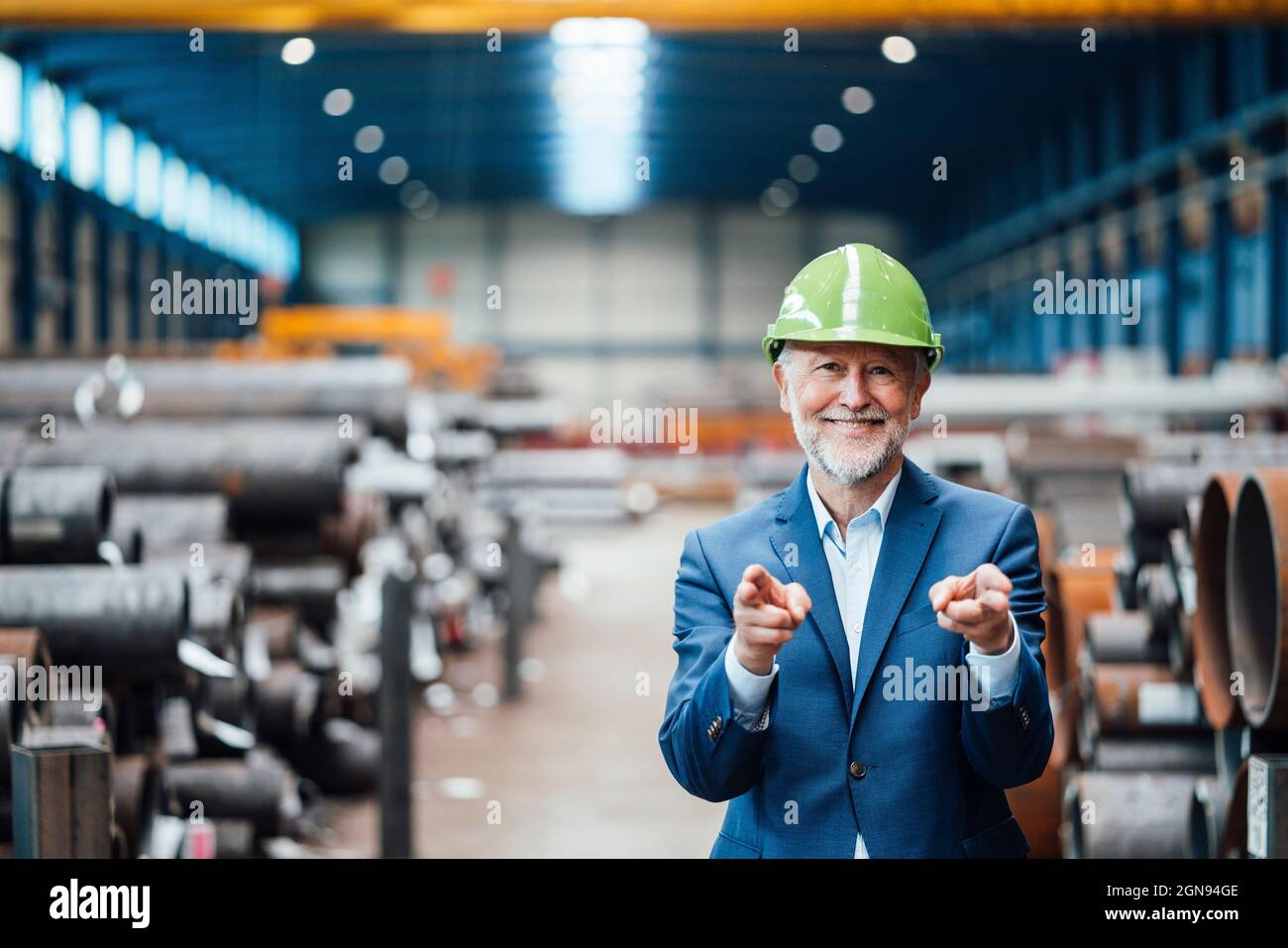 Smiling businessman at metal industry Stock Photo