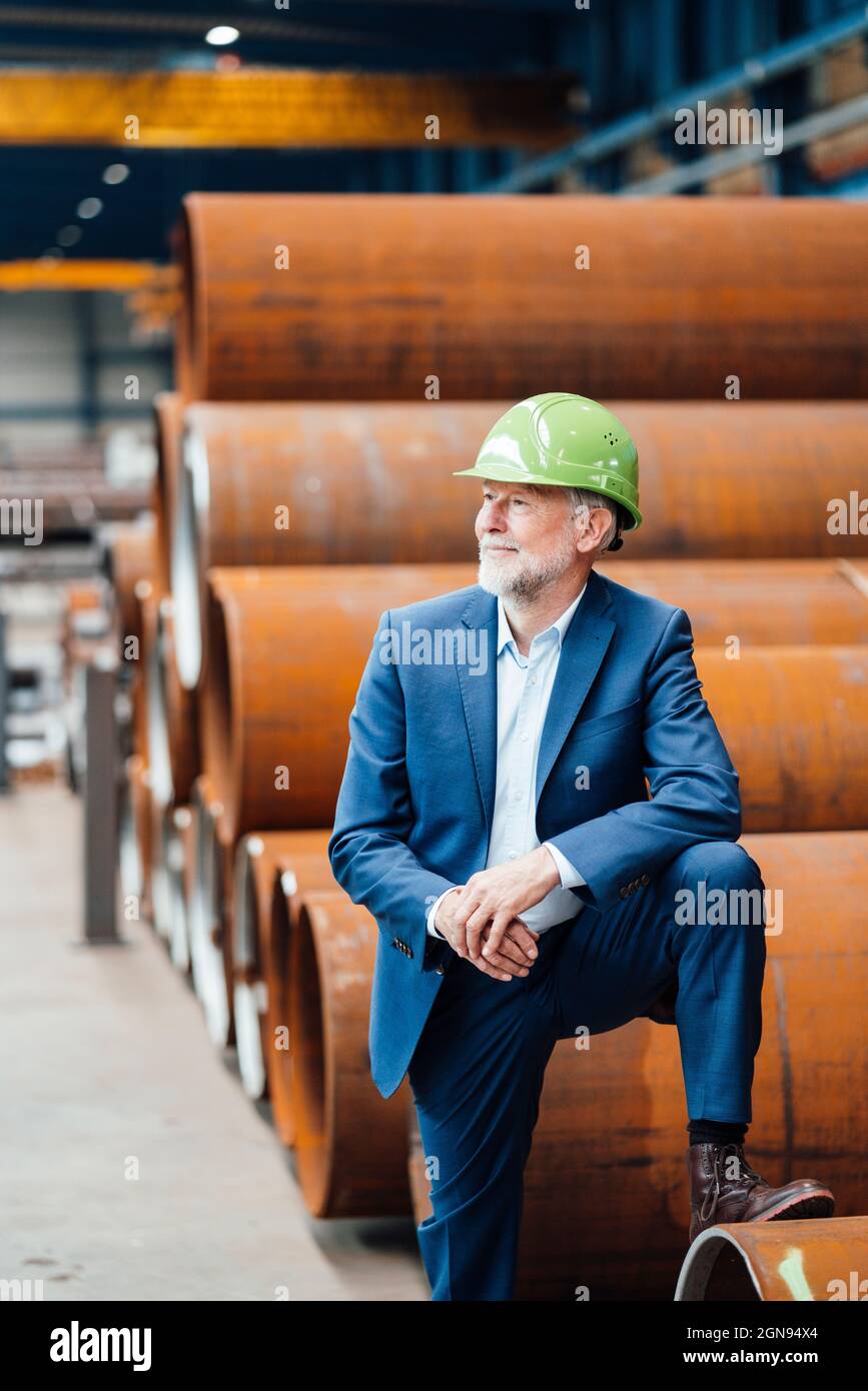 Male manager measuring metal with caliper in warehouse Stock Photo