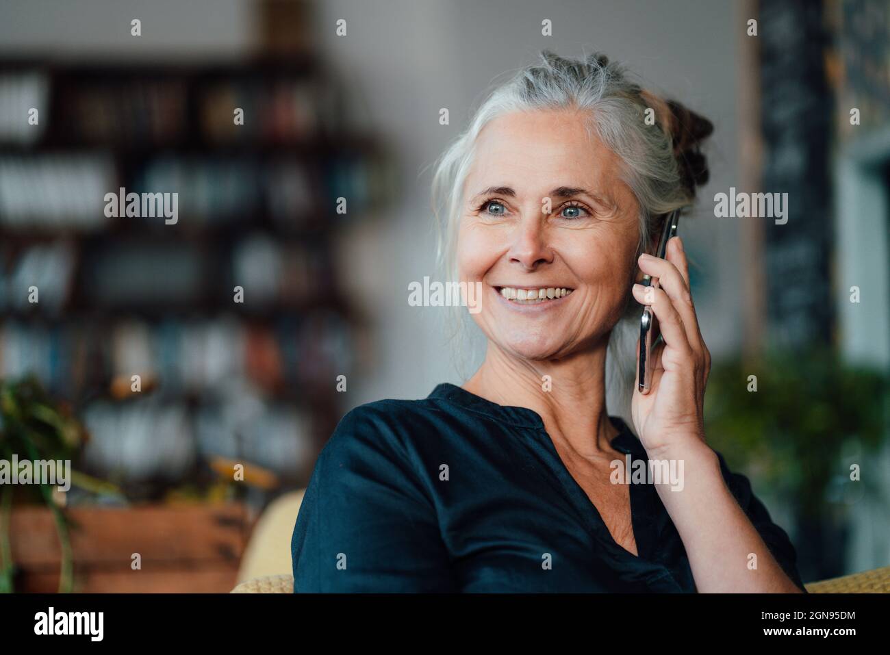Smiling female cafe owner wearing apron in coffee shop Stock Photo - Alamy