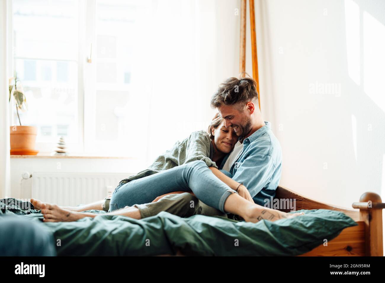 Male and female business colleagues discussing while working at home Stock Photo