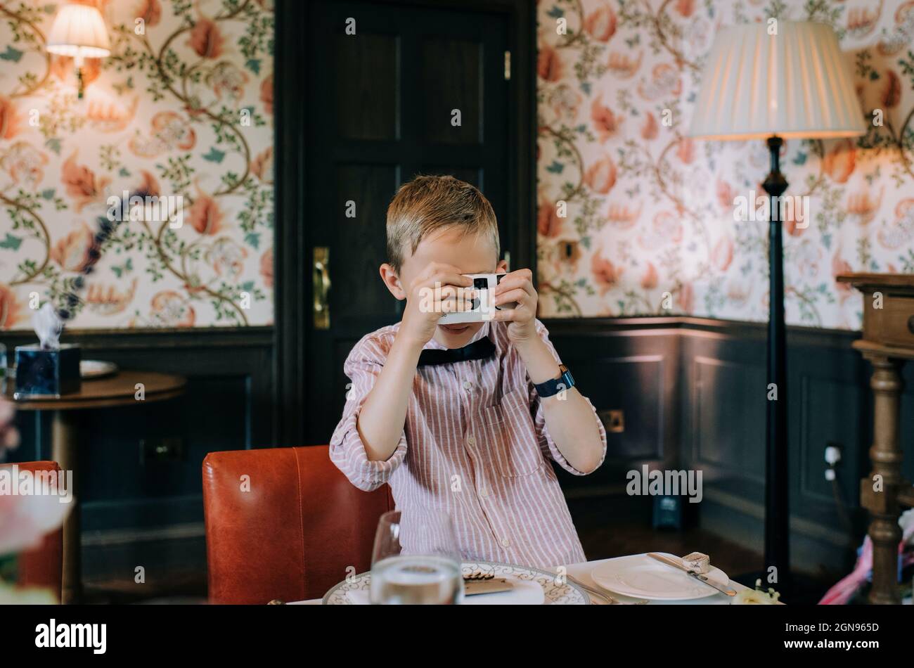boy taking pictures with disposable camera at a wedding Stock Photo