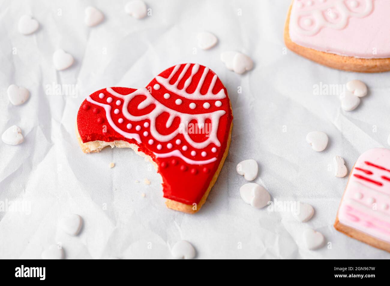 Studio shot of plate with heart shaped cookie missing single bite Stock Photo