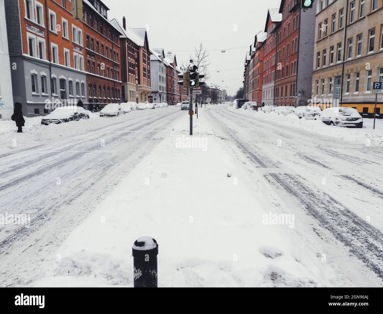 Winter landscape in the city of Braunschweig, Germany. Snow covered street and cars. Winter season with heavy snowfall Stock Photo