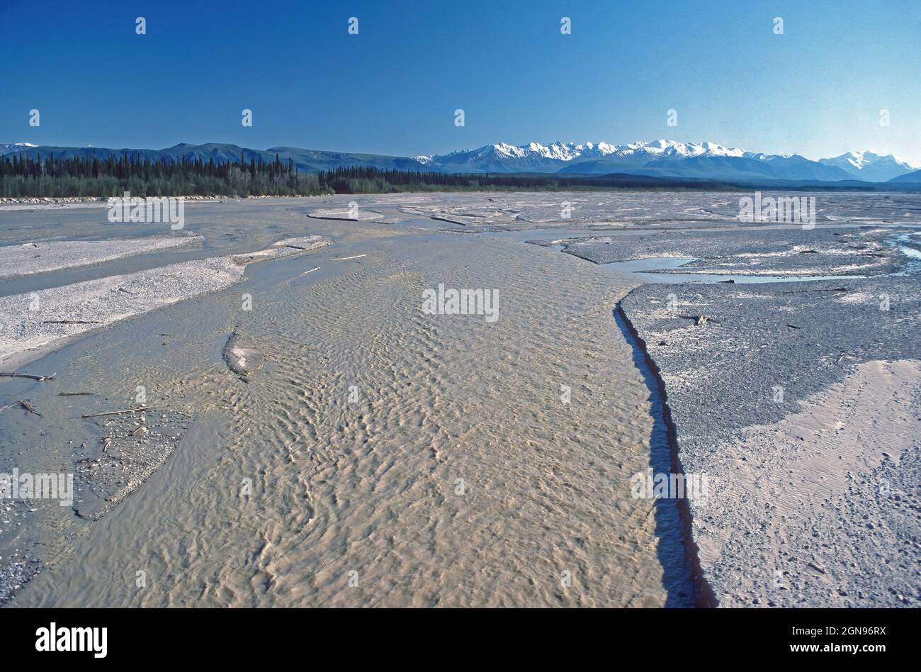 Glacial Stream Running From the Glaciated Mountains on the Tanana River and the Alaska Range along the Alaska Highway in Alaska Stock Photo