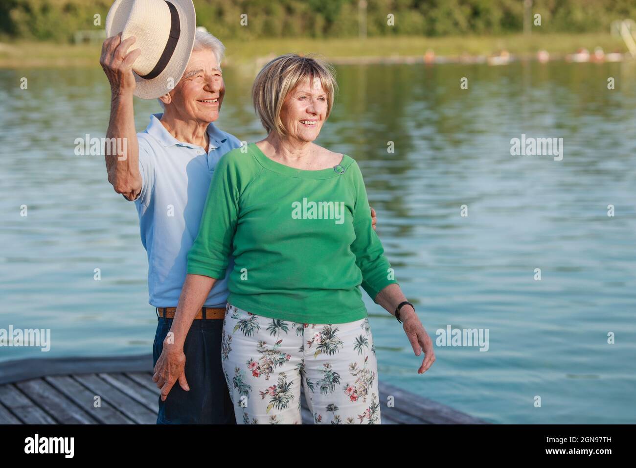 Smiling senior couple standing together on jetty Stock Photo