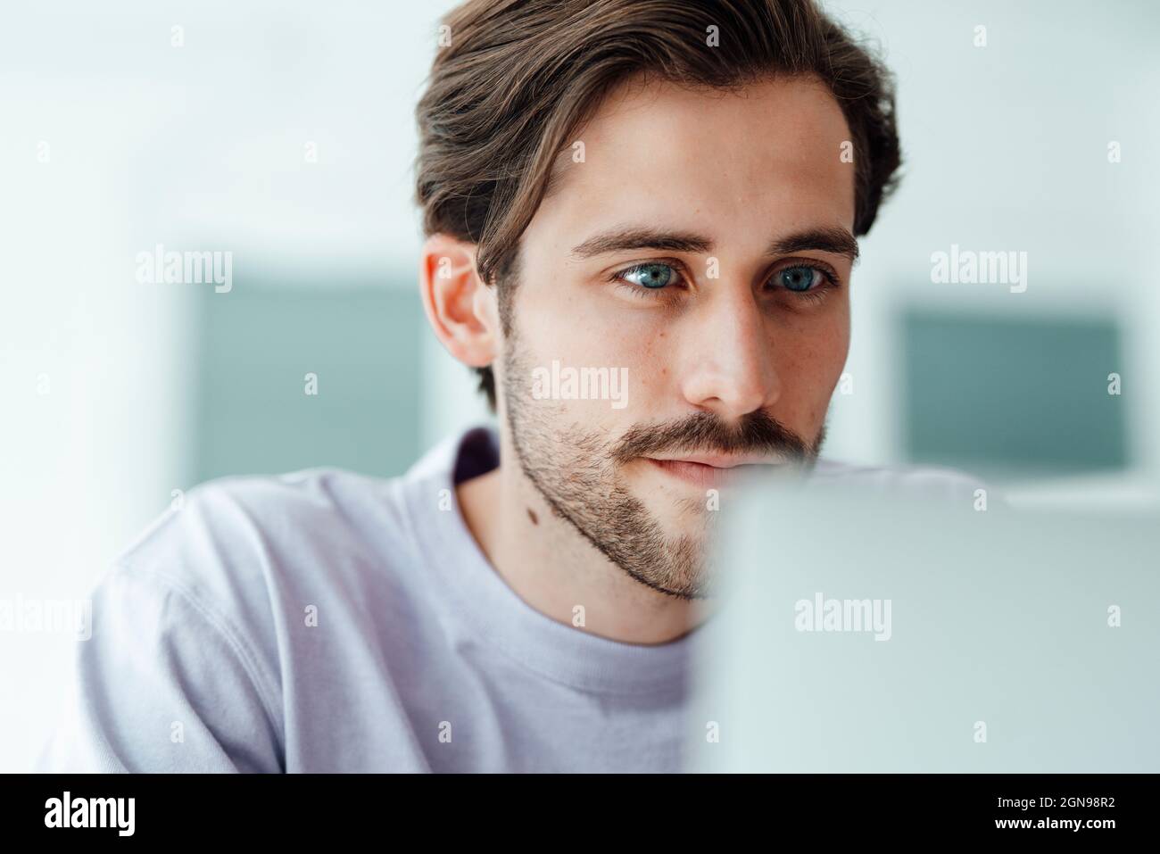 Young man using laptop at home Stock Photo