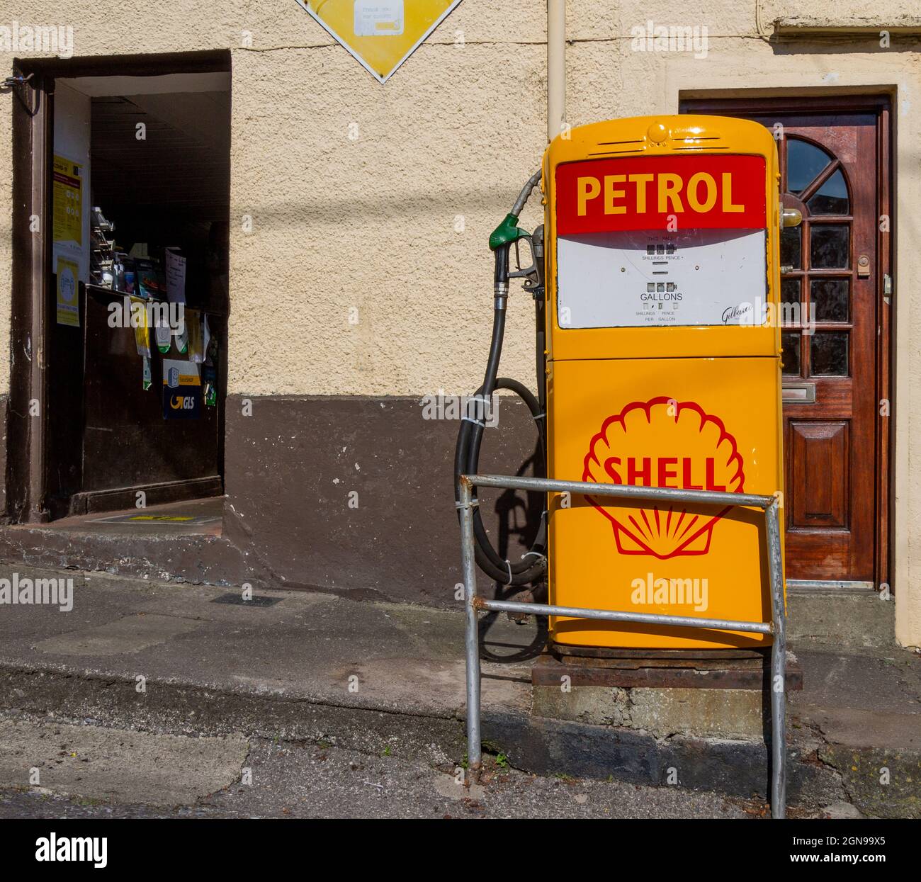 Vintage petrol pump or gas station pump outside Irish Village shop Stock Photo