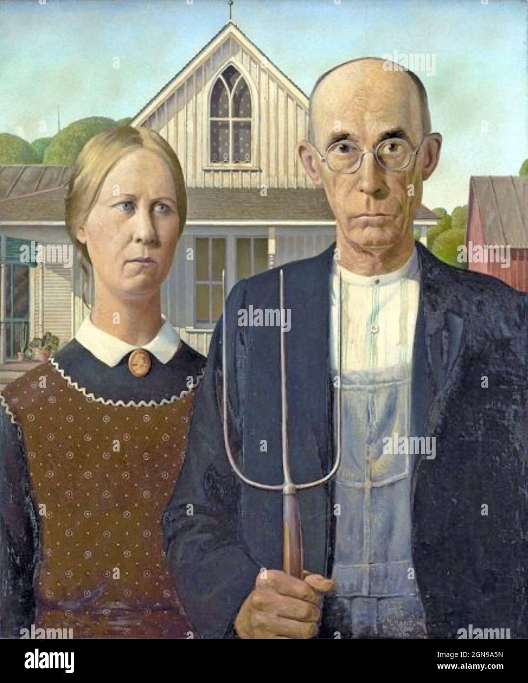 AMERICAN GOTHIC A farmer stands next to his daughter in the 10