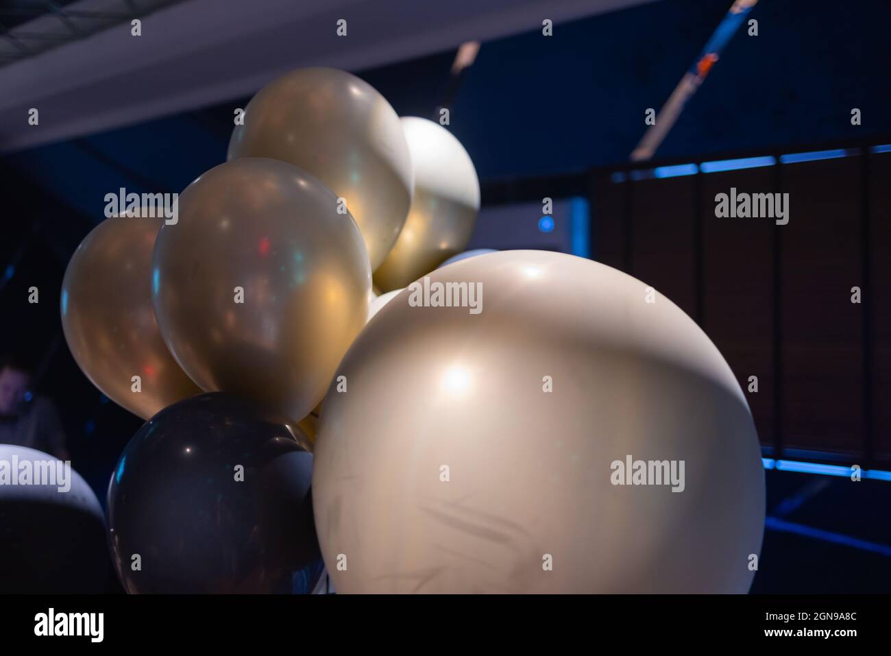 Silver star shaped helium balloons on blue Stock Photo