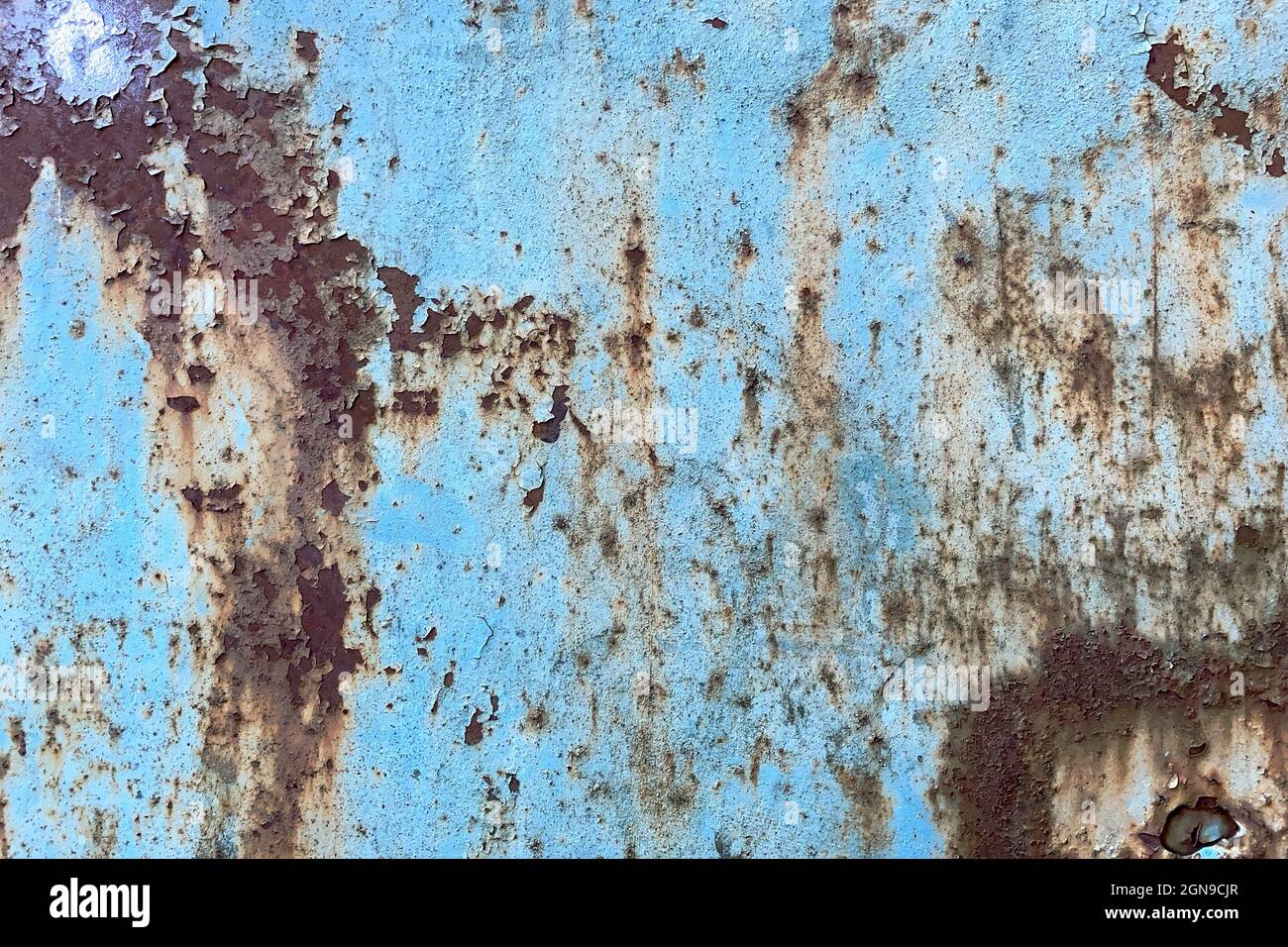 Damaged old peeling paint blue background rusty metal flat pallet. Cracked oil paint on aged metal surface. Close-up. Outdoors. Stock Photo