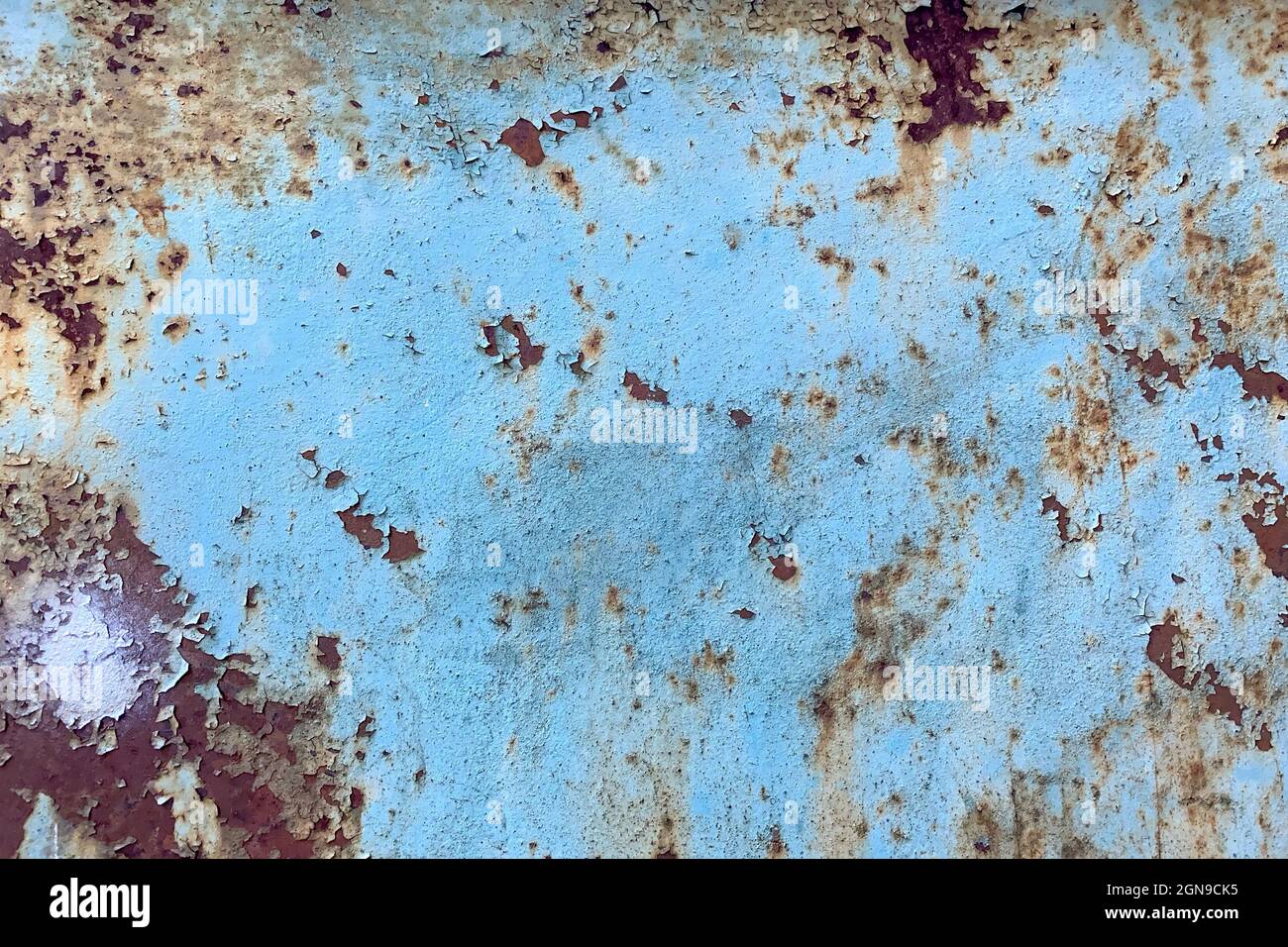 Damaged old peeling paint blue background rusty metal flat pallet. Cracked oil paint on aged metal surface. Close-up. Outdoors. Stock Photo