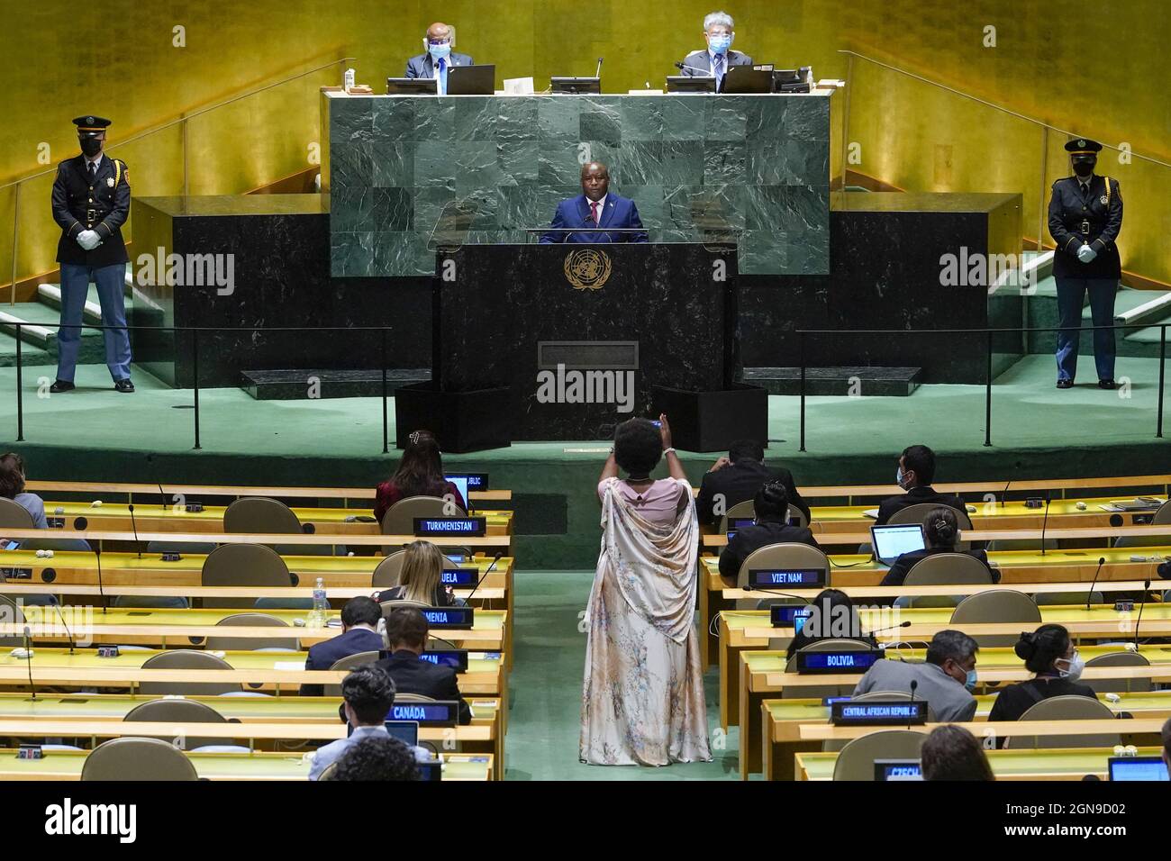 New York, United States. 23rd Sep, 2021. A delegate, bottom center, uses a smart phone to take a picture of Burundi's President Evariste Ndayishimiye as he addresses the 76th session of the United Nations General Assembly (UNGA) at U.N. headquarters on September 23, 2021 in New York City. Pool Photo by Mary Altaffer/UPI Credit: UPI/Alamy Live News Stock Photo