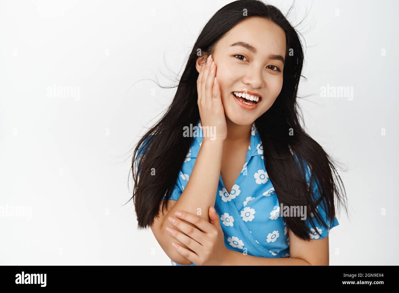 Skin care and women beauty. Attractive brunette asian girl touching her ...