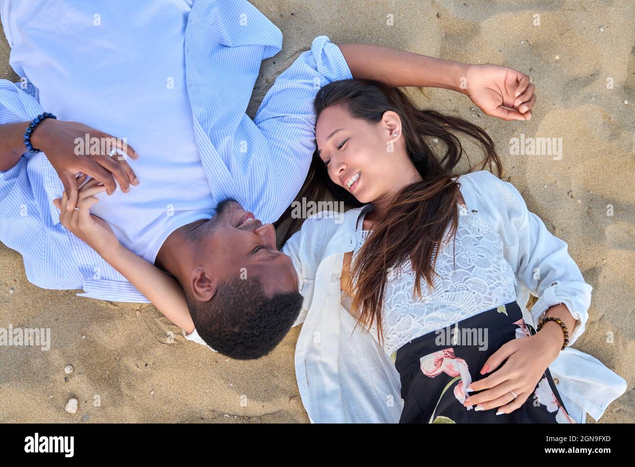 Top view of a young couple in love on the sand Stock Photo