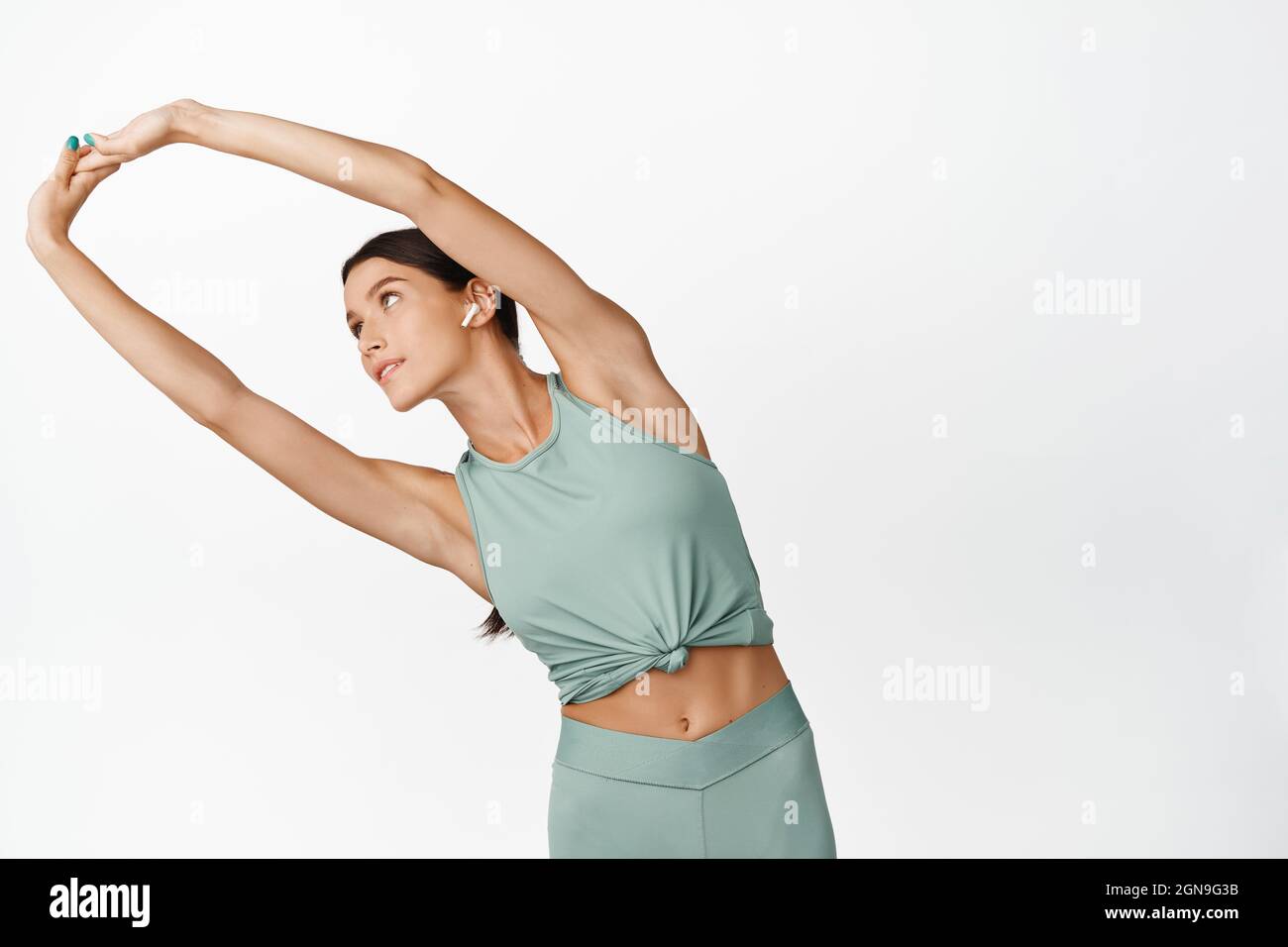 Young Female Athlete Doing Arm Stretches Warm Up Before Yoga Class Fitness Girl Workout In Gym White Background Stock Photo Alamy