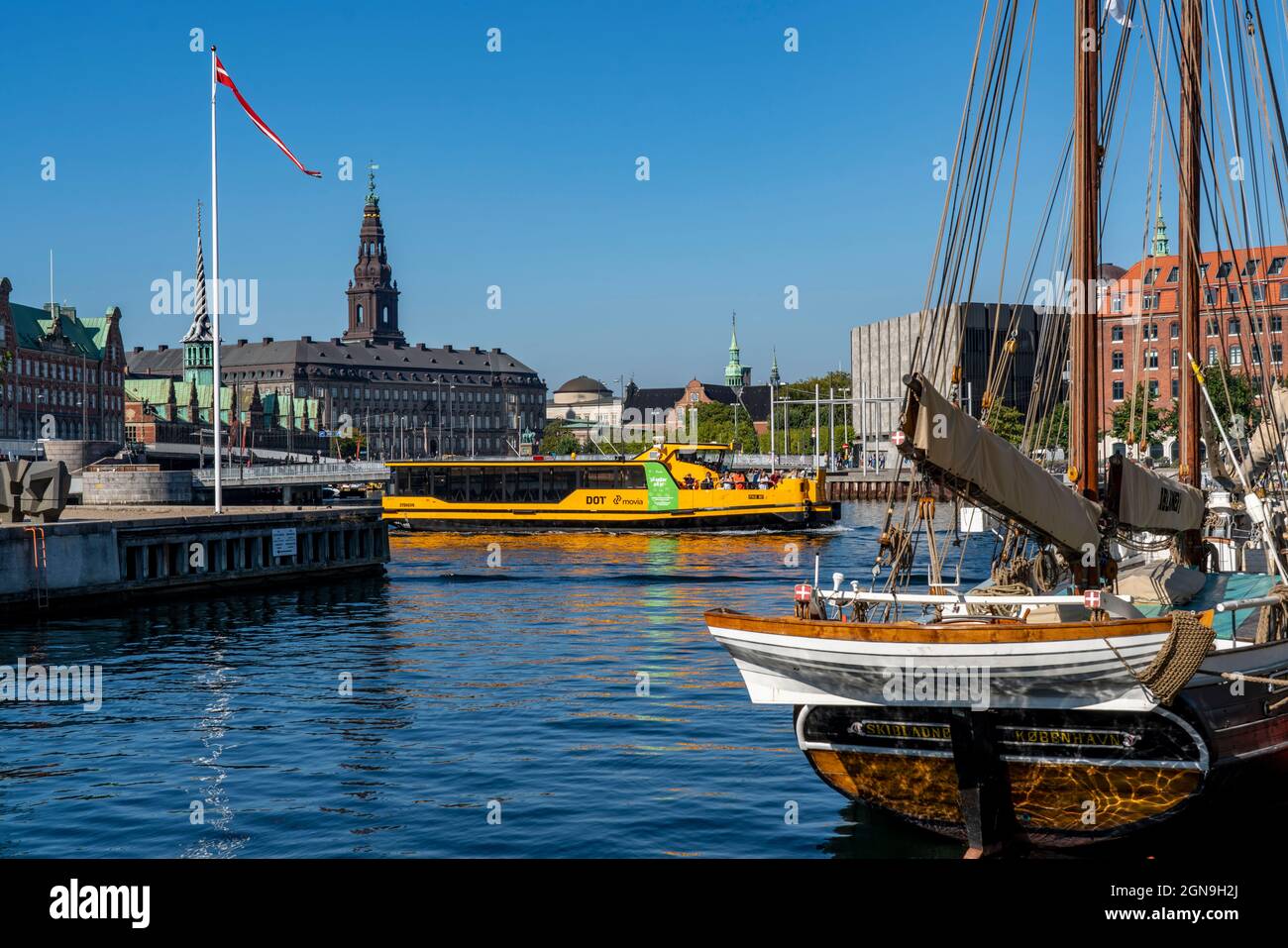 Port of Copenhagen, harbour bus, ferry, local transport, Christiansborg Castle Church in the back, Denmark, Stock Photo