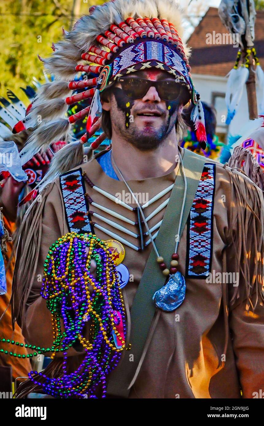 A Mardi Gras reveler dressed as an Indian marches during the Joe Cain