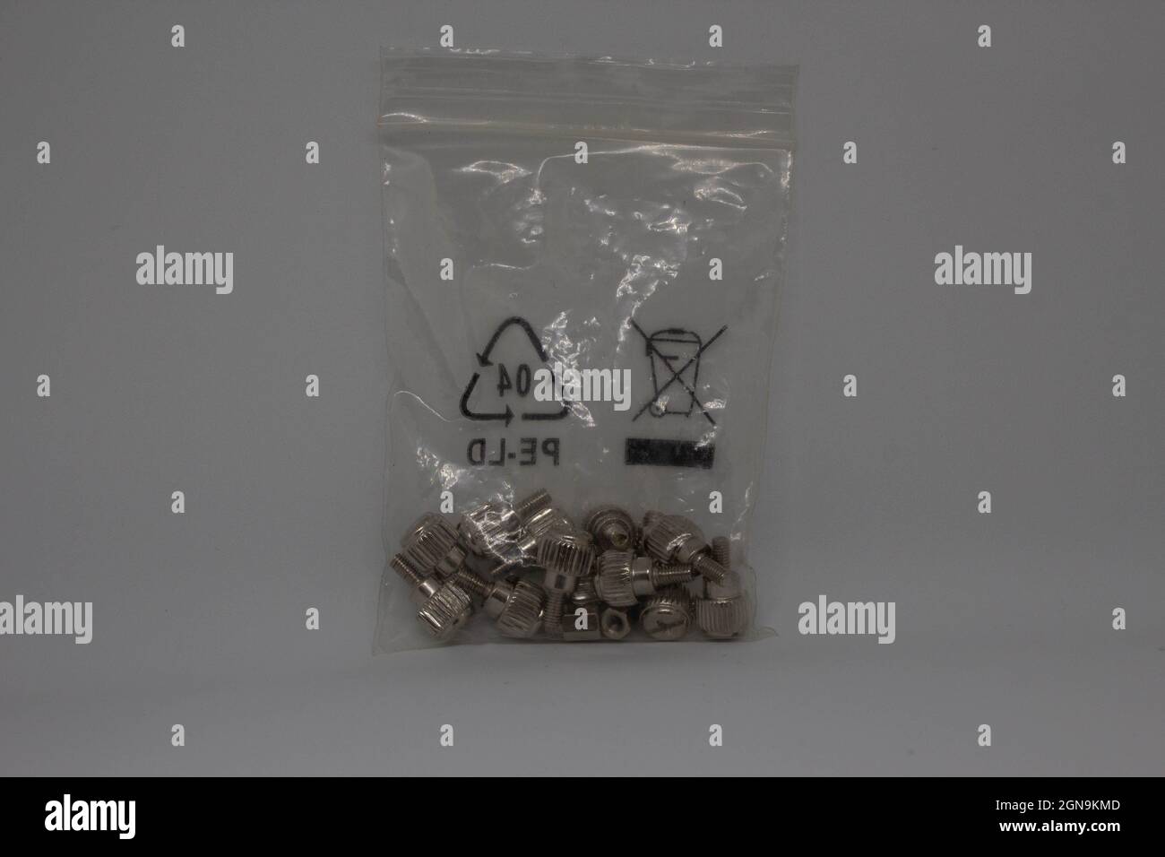 Screws in a small plastic bag. Pc screws. Computer screws together in a