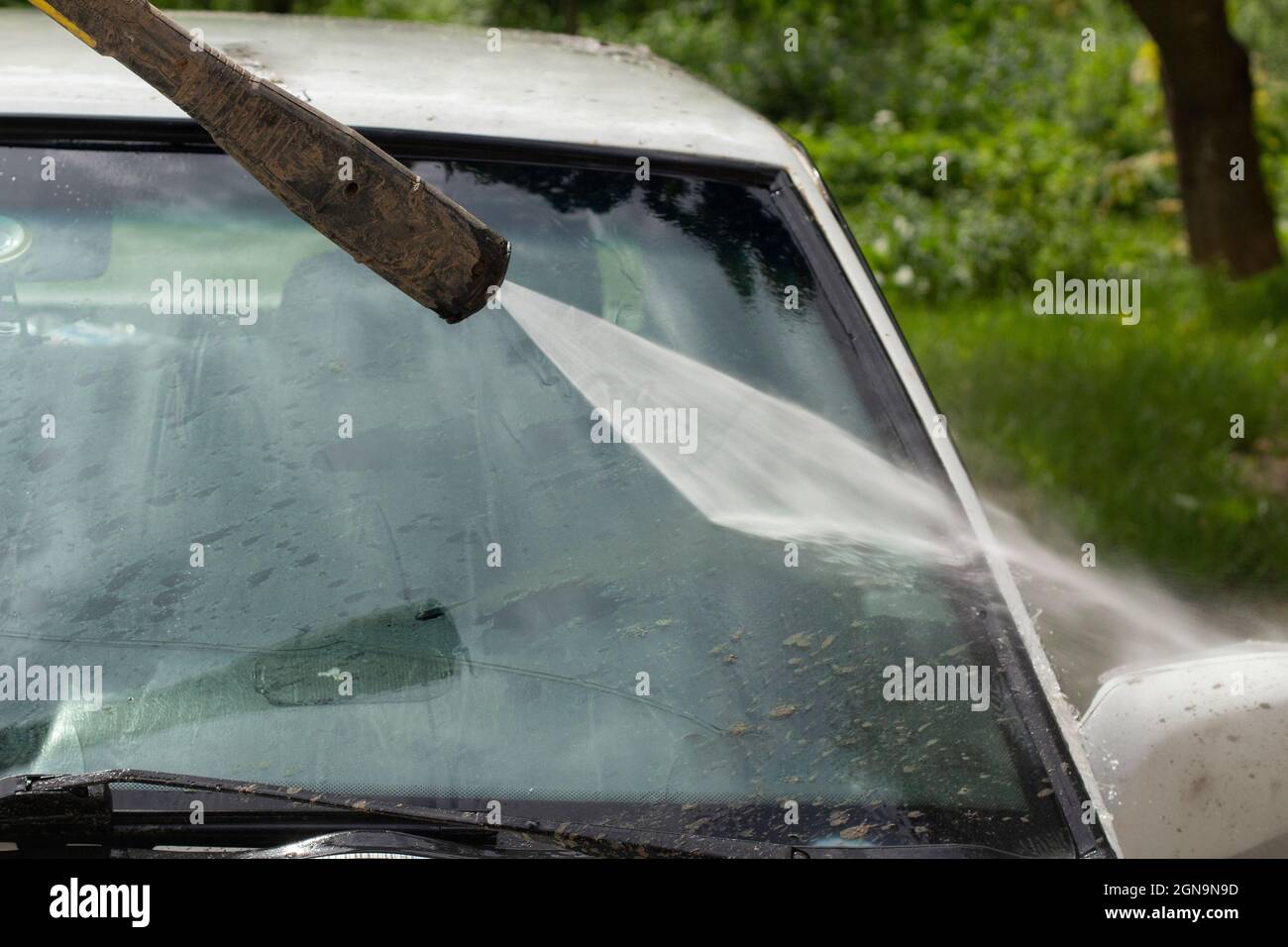 Washing the windshield from dirt. The car is washed by the pressure of