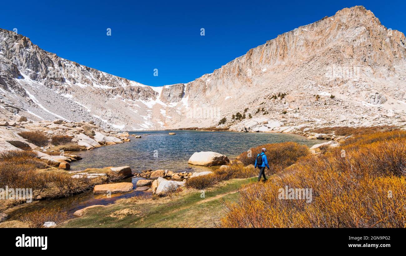 Hiker exploring the Cottonwood Lakes Basin at Lake 4, John Muir