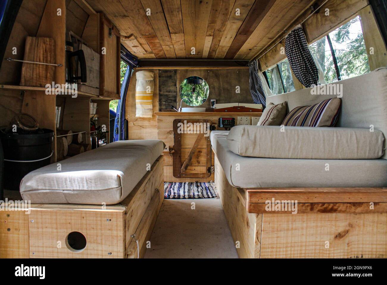 Beautiful view of couch inside a vintage wooden van Stock Photo - Alamy