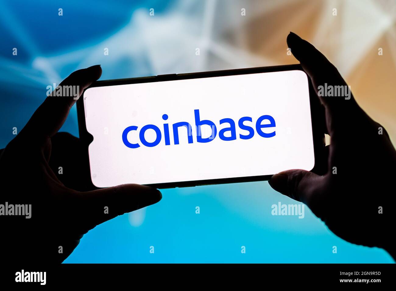 In this photo illustration a Coinbase logo seen displayed on a ...