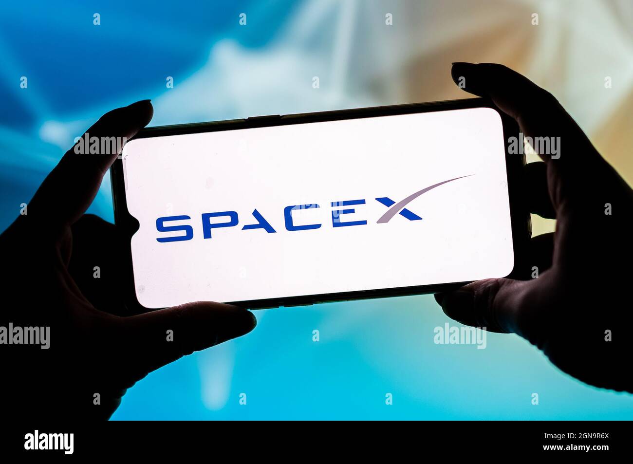 In this photo illustration a Spacex logo seen displayed on a smartphone