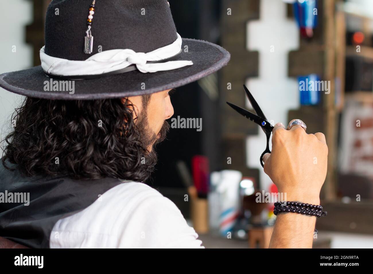 Attractive hipster man with black scissors in his hands Stock Photo