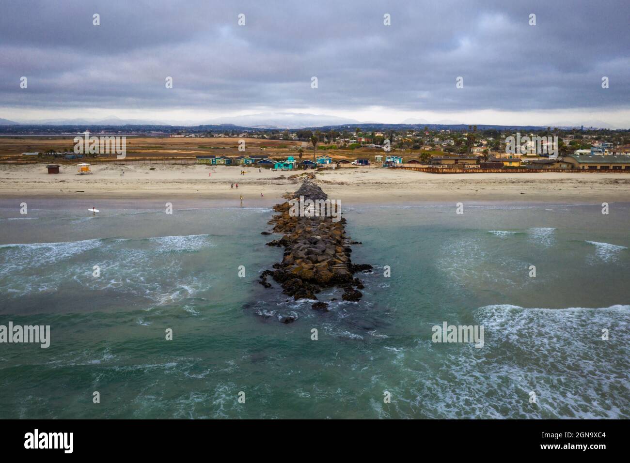 Jetty, surfers and beach bungalows in Imperial Beach, drone  Stock Photo