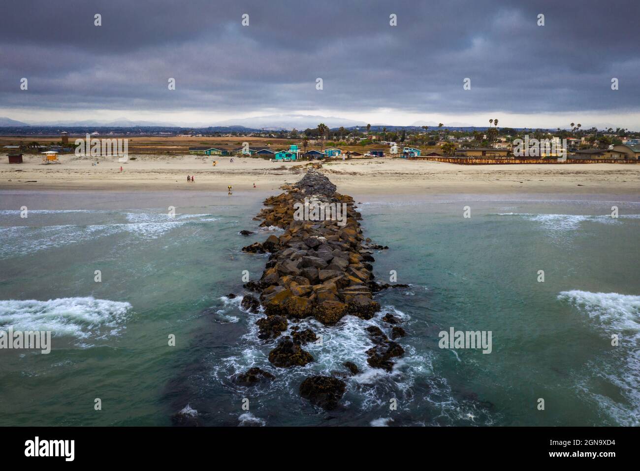 Waves breaking on rock jetty in Southern California Stock Photo