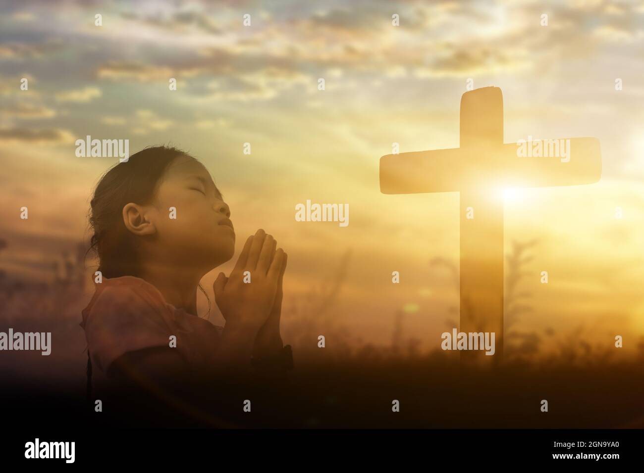 Young girl raising hands worship and praise God at sunset background.  Christian Religion concept Stock Photo - Alamy