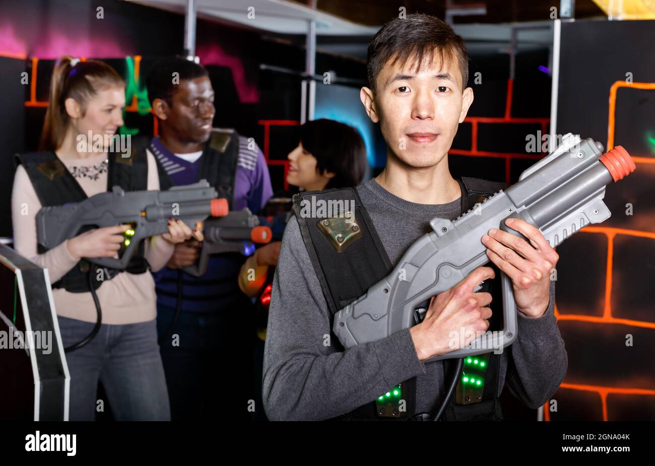 Asian man with laser gun ready for lasertag game Stock Photo - Alamy
