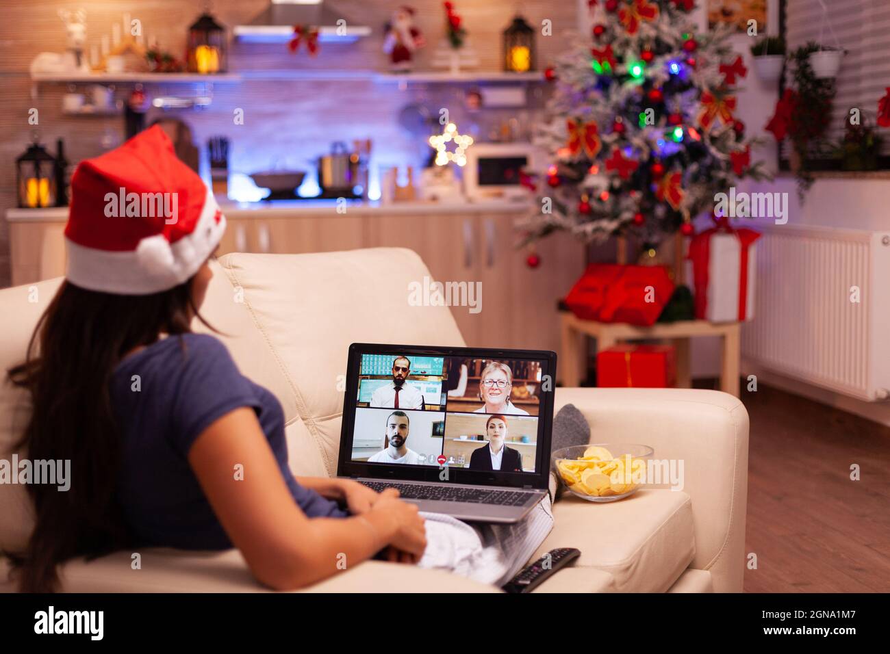 Woman discussing with remote friends during online videocall meeting ...