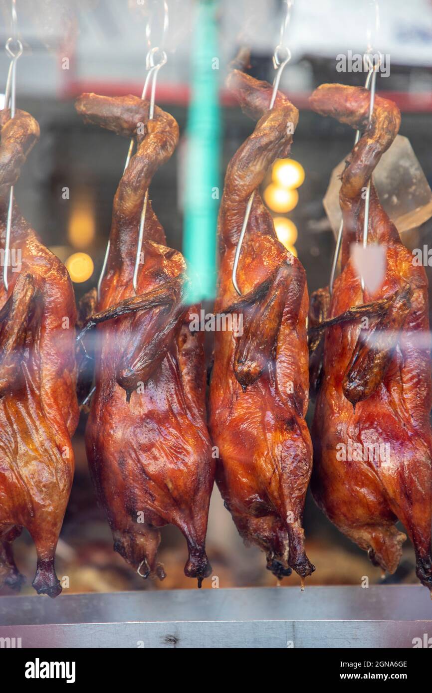 Roasted ducks hanging in a restaurant window in Chinatown in San