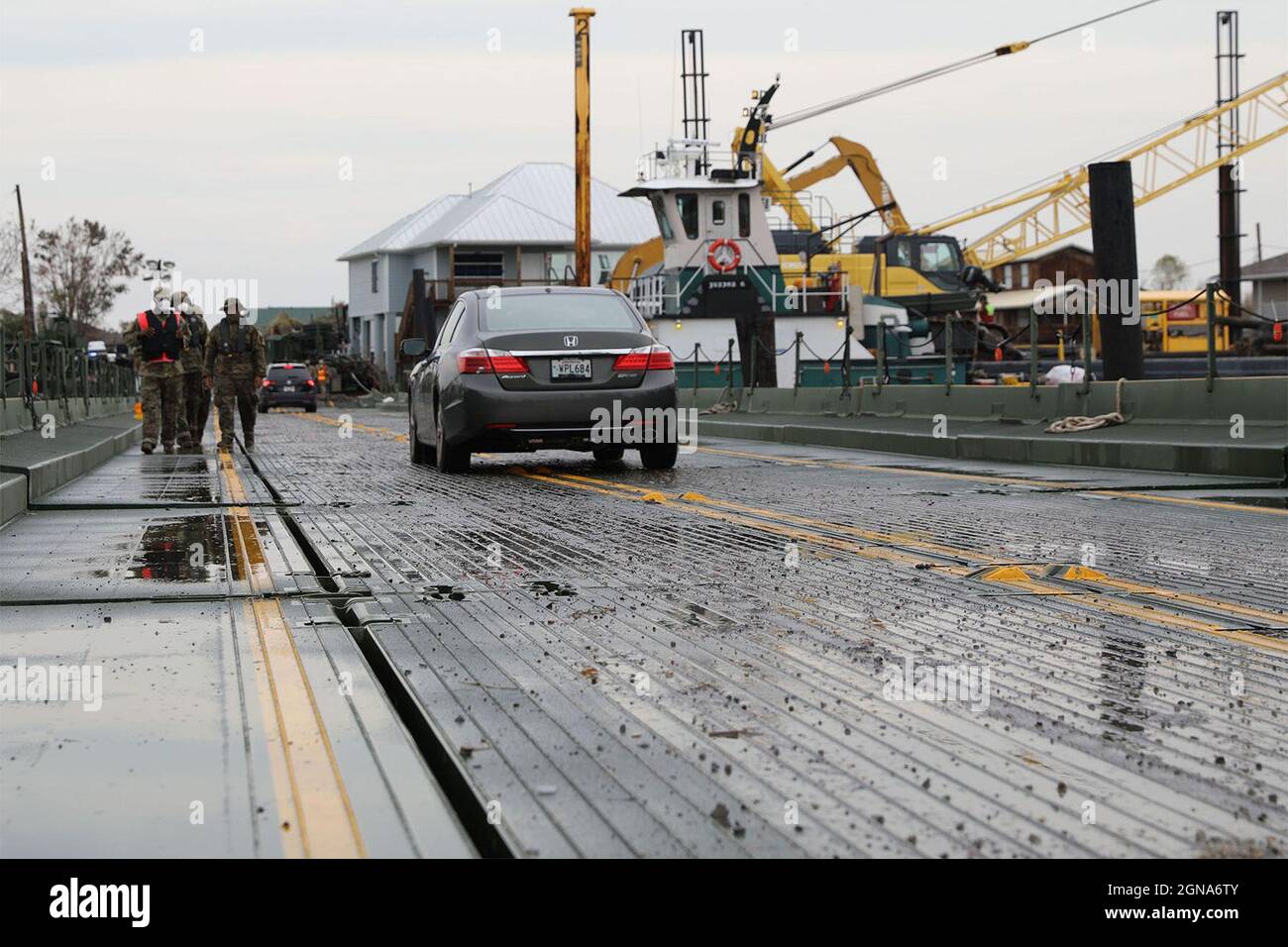 Cars cross an Improved Ribbon Bridge after Hurricane Ida in Jean Lafitte, La., Sept. 8, 2021. Louisiana National Guardsmen assigned to the 2225th Multi-Role Bridge Company, 225th Engineer Brigade constructed the temporary floating bridge after storm surge from Ida damaged the only bridge that connects to Barataria. (U.S. Army National Guard photo by Staff Sgt. Josiah Pugh) Stock Photo