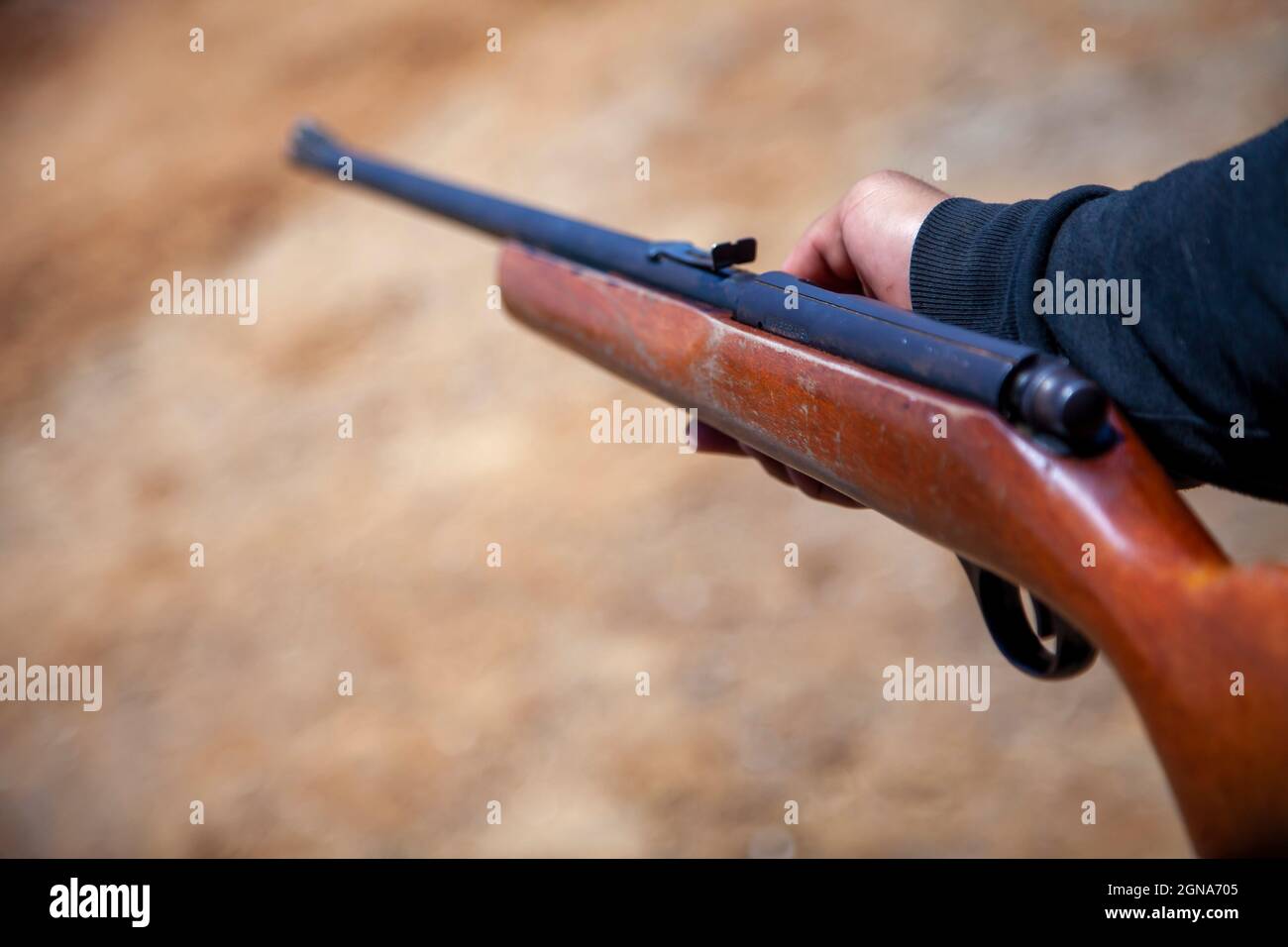 person holding an old vintage gun made of wood Stock Photo