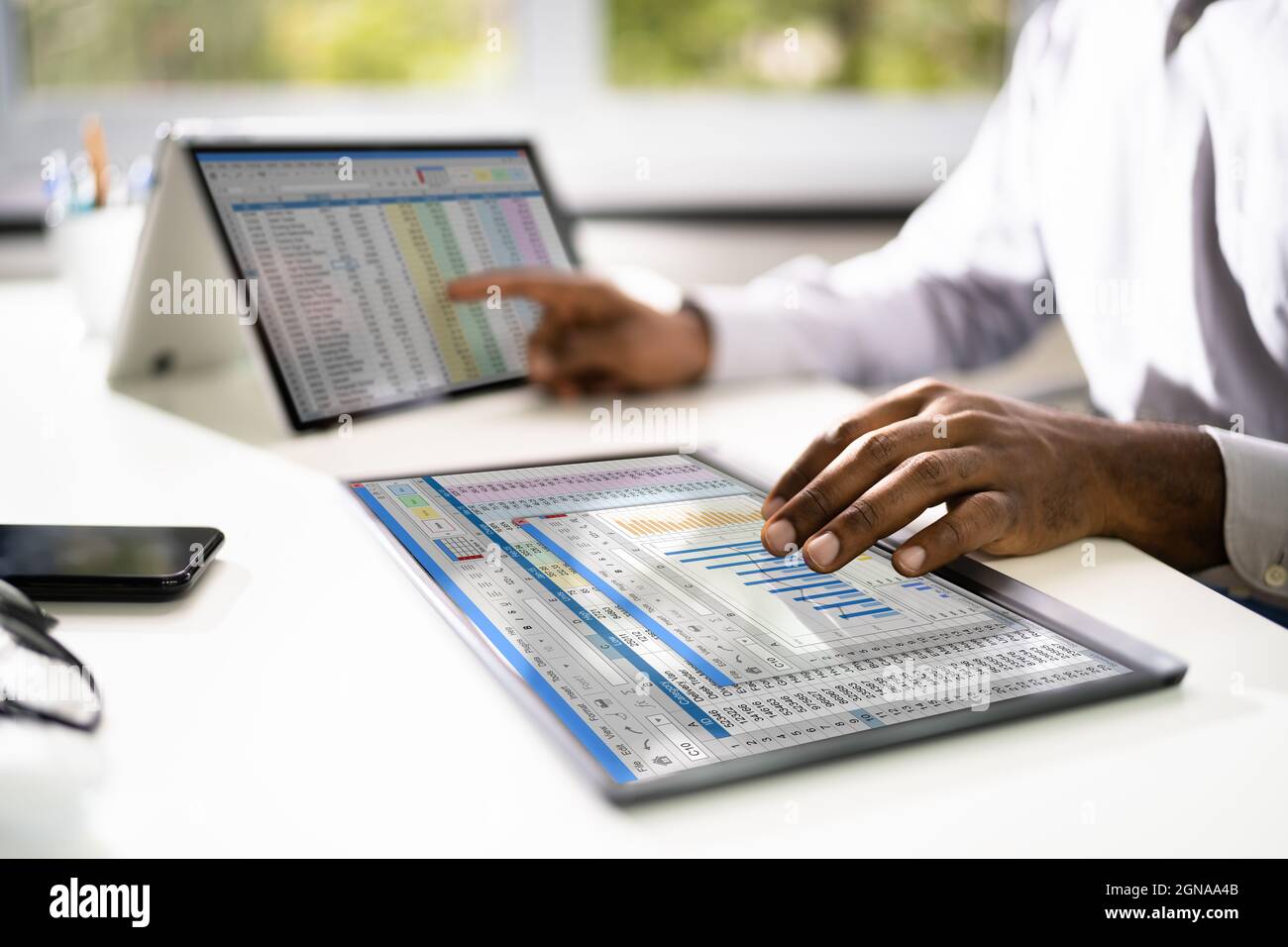 Electronic Spreadsheet Analyst Or Auditor Using Software On Hybrid Laptop Stock Photo