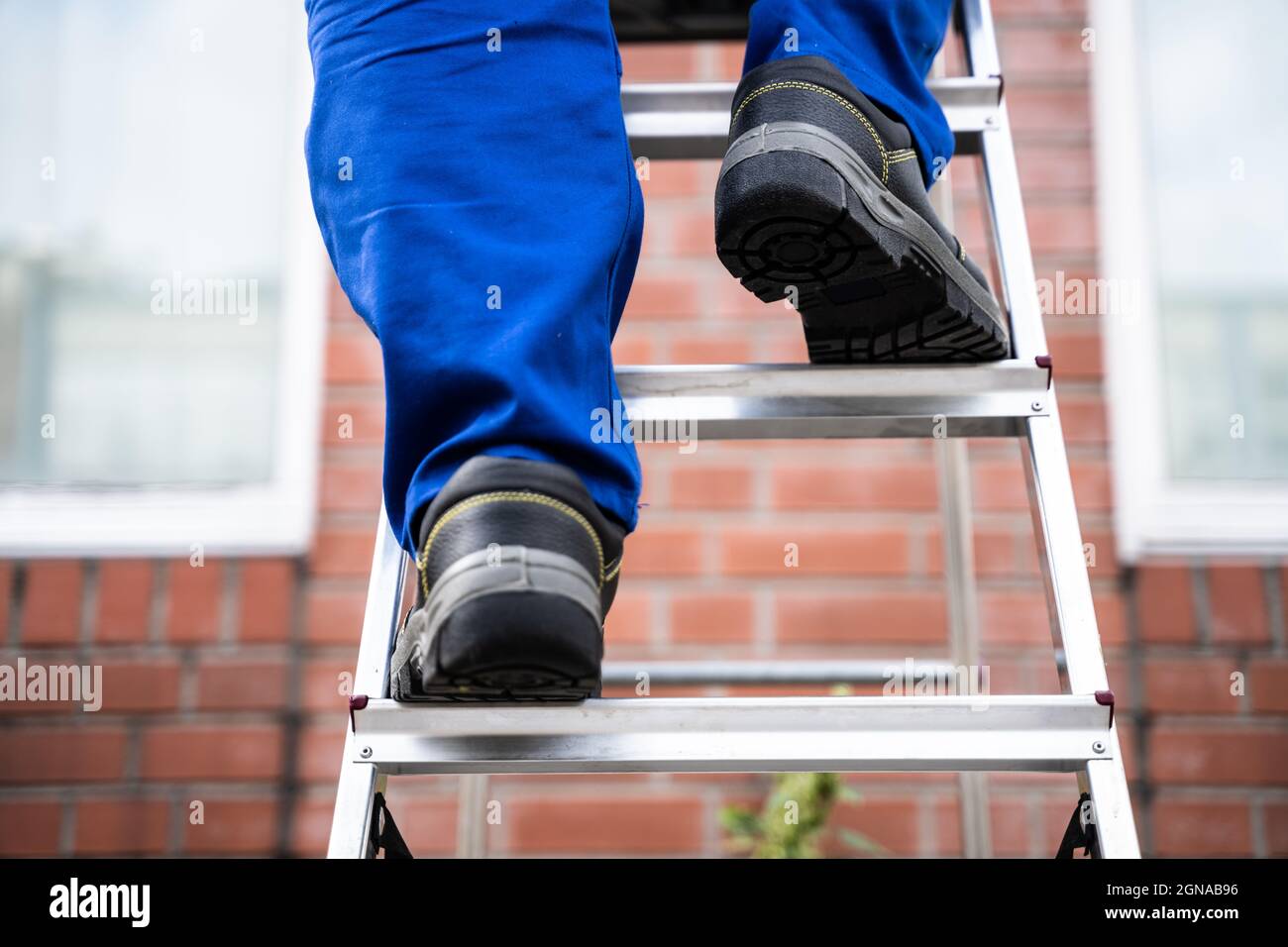 Man Climbing Step Ladder In Safety Shoes Stock Photo Alamy