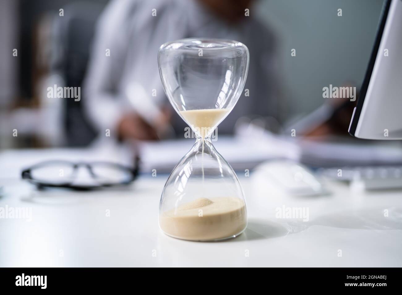 Late Invoice And Billing Deadline With Hourglass At Desk Stock Photo ...