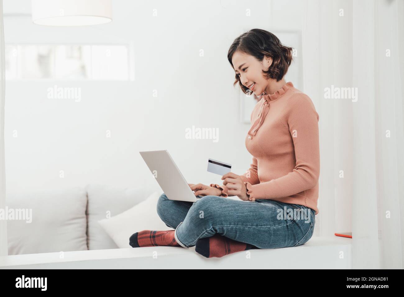 Beautiful asian woman shopping online via notebook computer on Christmas day Stock Photo
