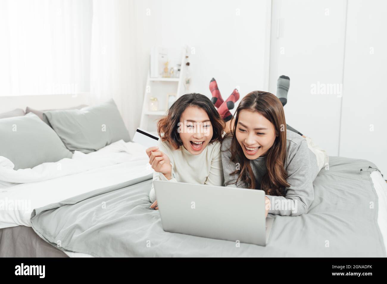 Beautiful female friendship enjoy weekend activity lifestyle with technology at home. Stock Photo