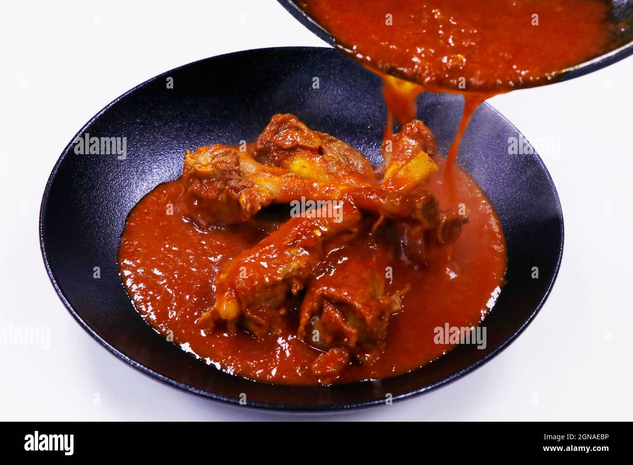 slow cooked indian lamb or mutton shank curry, also known as nalli rogan josh Stock Photo Alamy