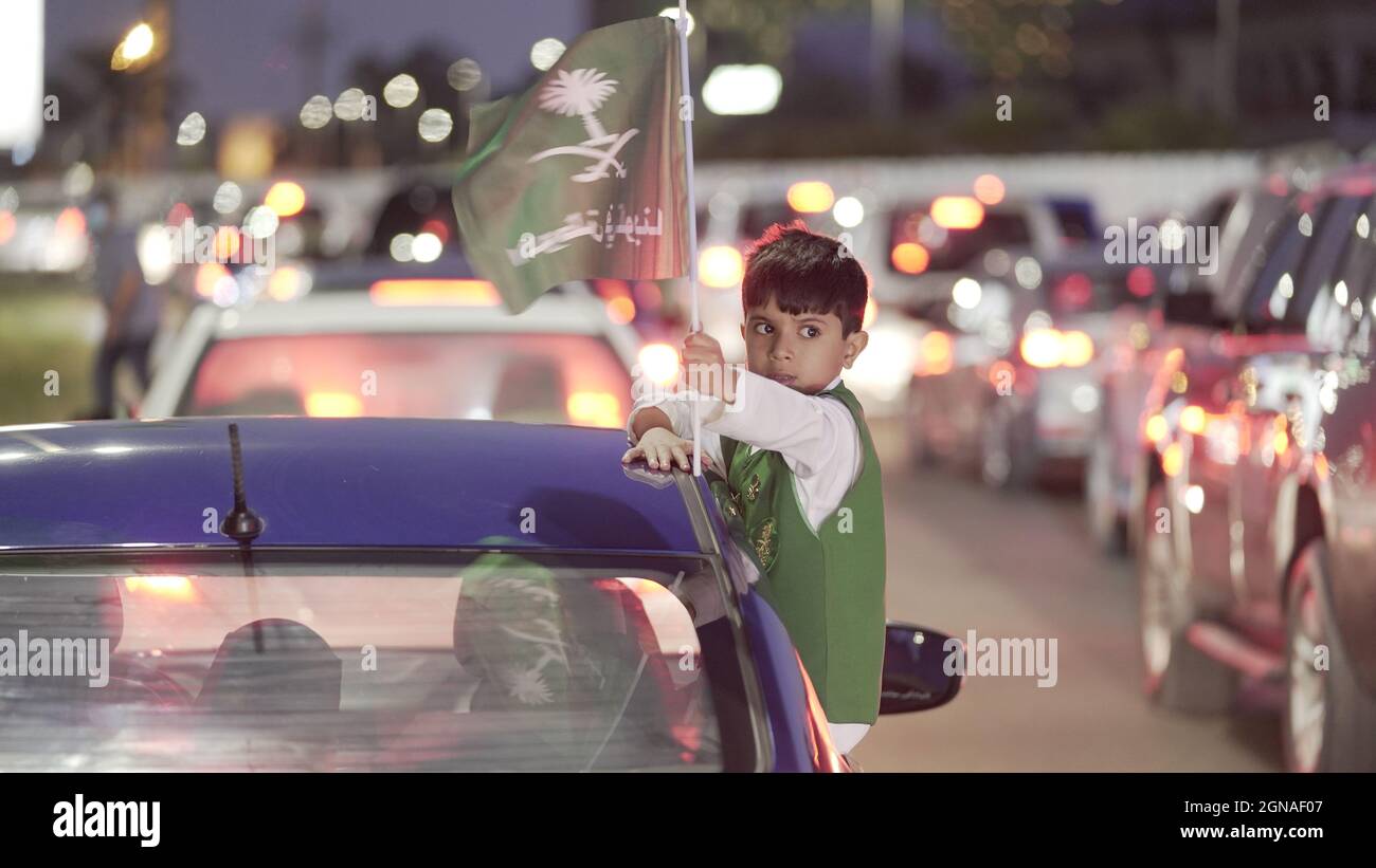 Riyadh, Saudi Arabia. 23rd Sep, 2021. A child leans out of the car window to watch the national day firework show in Dammam, Saudi Arabia, Sept. 23, 2021. Credit: Mohamed Nasr/Xinhua/Alamy Live News Stock Photo